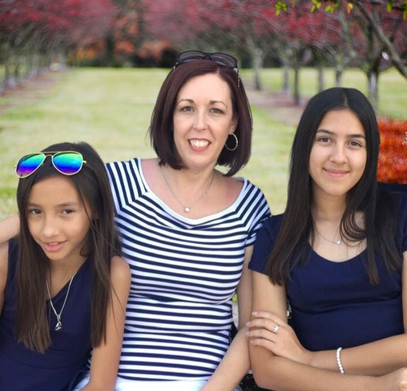 Liz and her 2 nieces sitting in a park